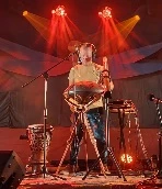 Chewy playing djembe at an outdoor festival