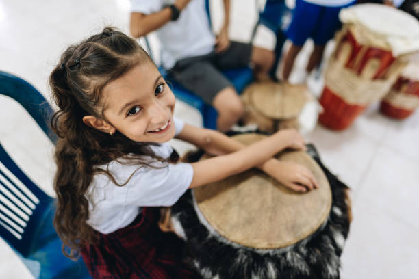 Child playing djembe drum at a birthday party